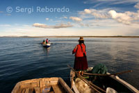 Una mujer en una barca en el Lago Titicaca cerca de una isla habitada por Uros.